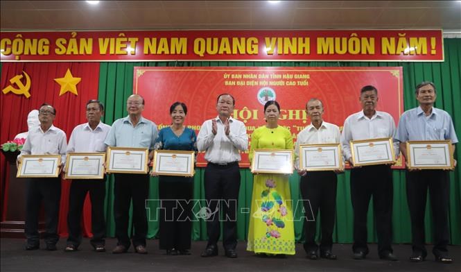 Tặng Bằng khen của UBND tỉnh cho các tập thể và cá nhân có thành tích xuất sắctrong thực hiện Đề án nhân rộng mô hình CLB liên thế hệ tự giúp nhau giai đoạnđến năm 2025. Ảnh: Hồng Thái/TTXVN