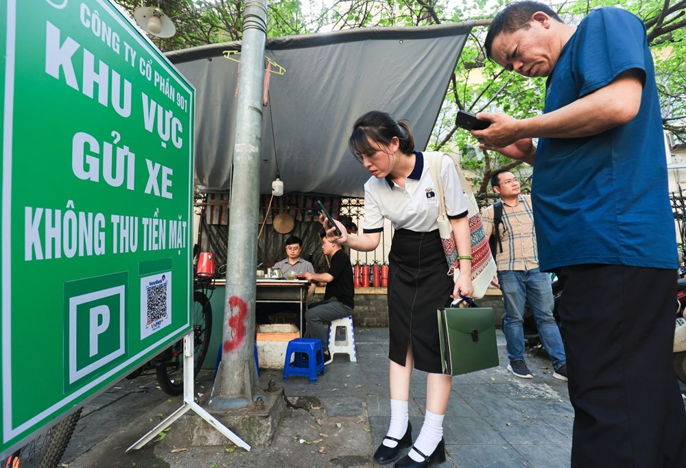 Người dân thanh toán dịch vụ gửi xe không dùng tiền mặt. Ảnh: Lê Khánh