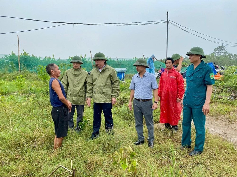Chủ tịch UBND xã Ô Diên trò chuyện với người dân sống ven sông Hồng trên địa bàn. Ảnh: Nguyễn Hòe