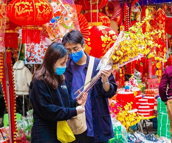 Hà Nội: Nhiều người dân đã ý thức đeo khẩu trang khi đi sắm Tết - Anh 5